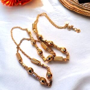 Gold Tone Long Faceted Necklace by Cookie Lee